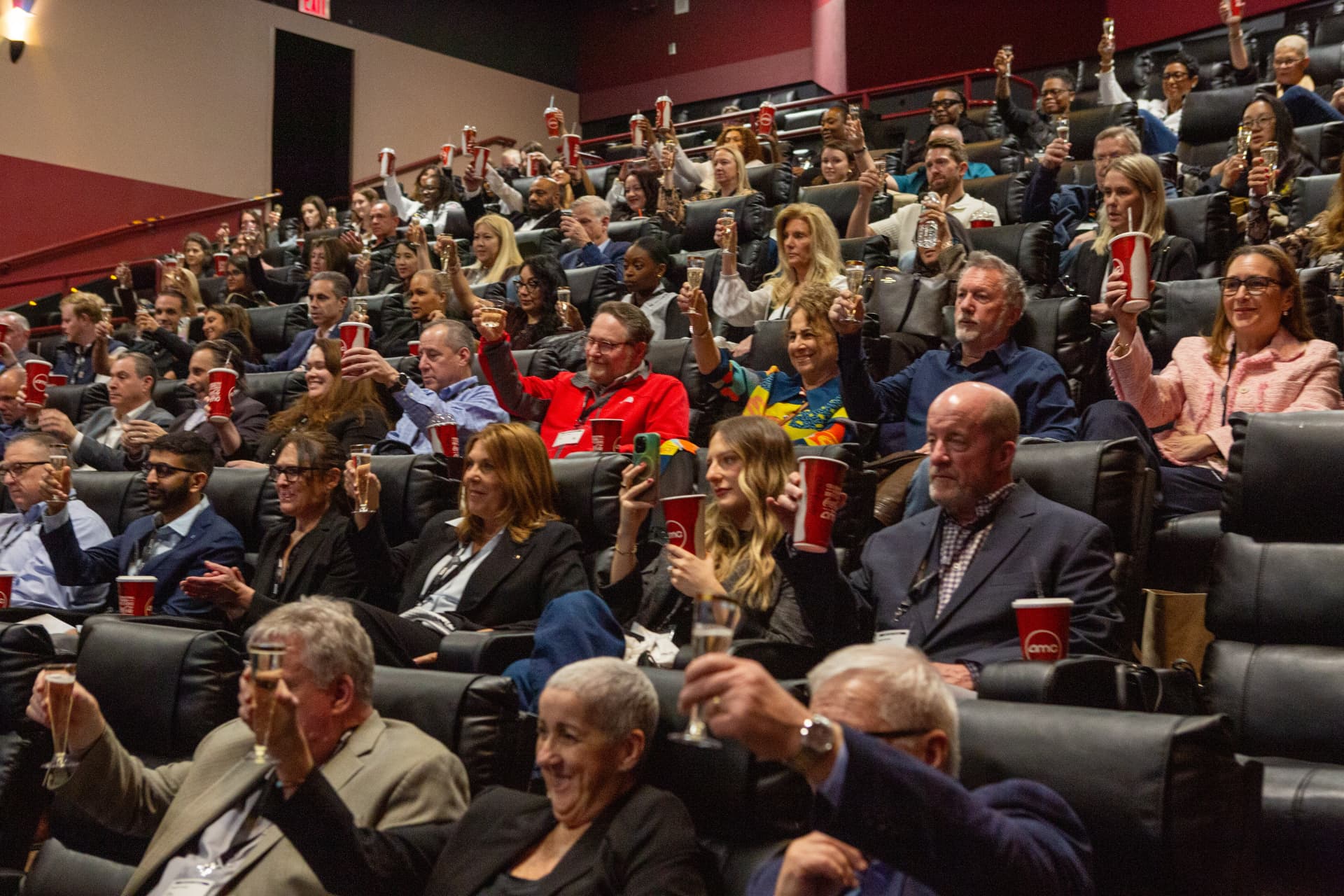A packed audience raises a glass at the New York screening