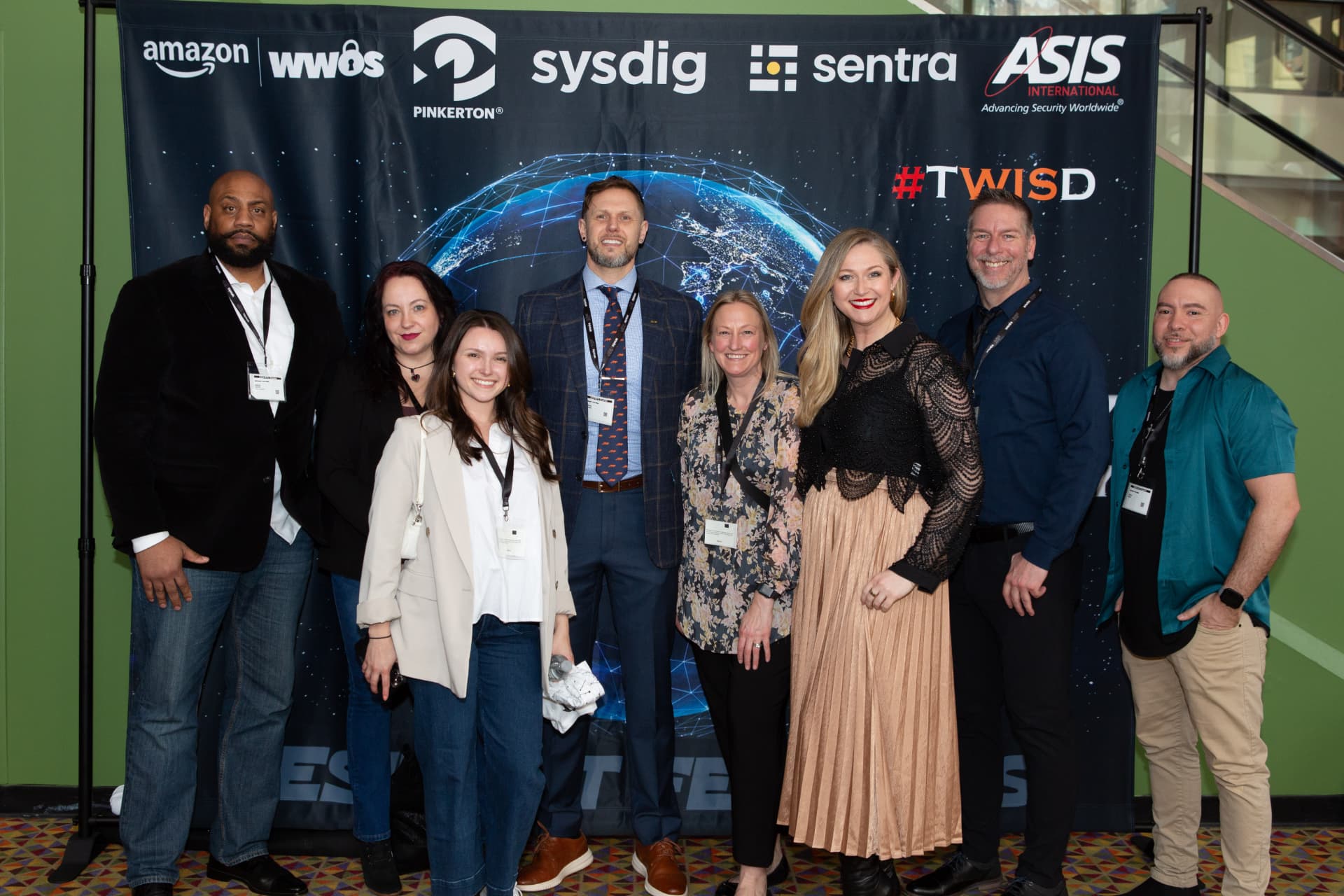 Sponsors and guests in front of the backdrop