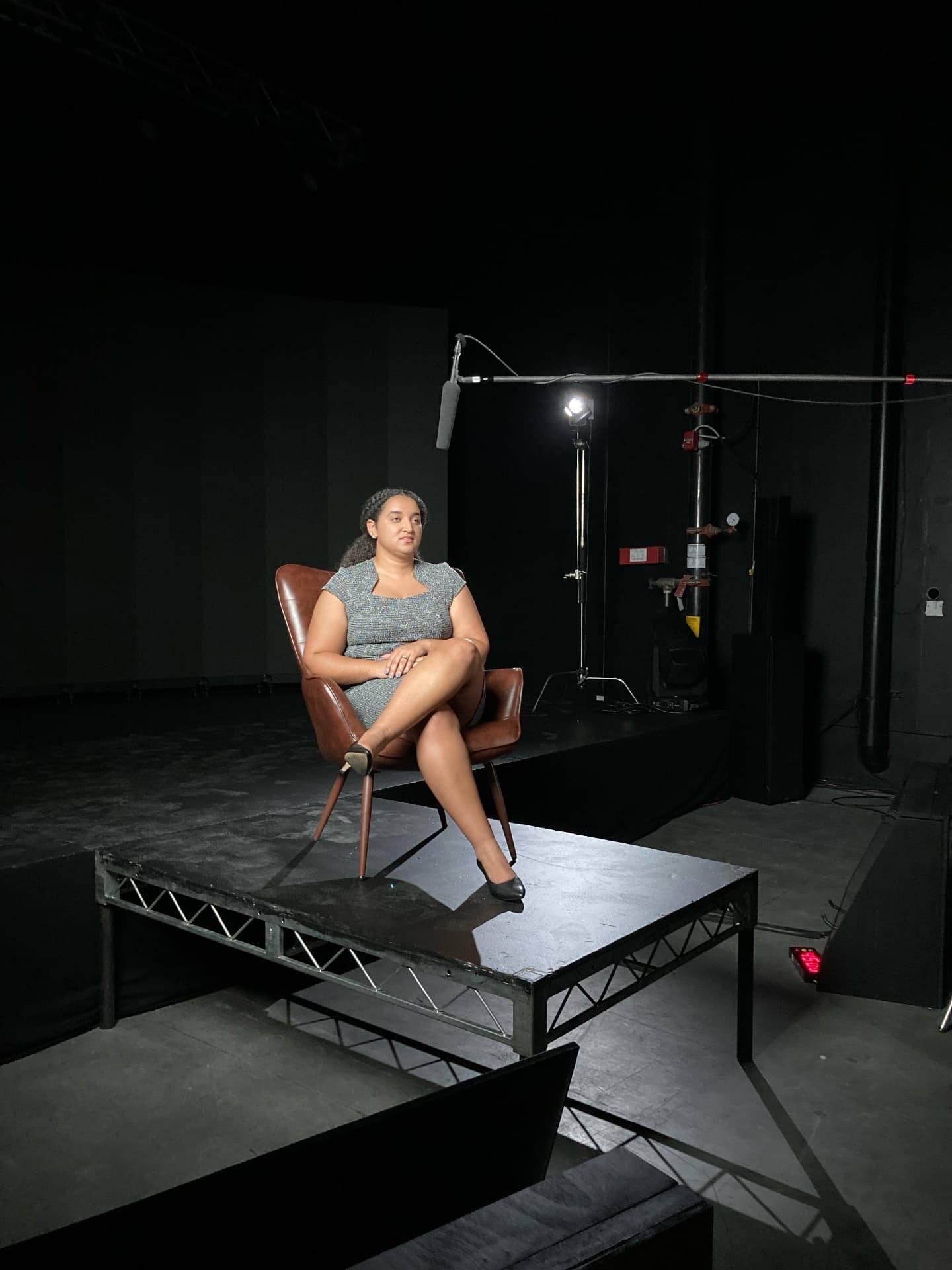 A woman seated for a documentary interview at the 2024 conference, with camera and microphone equipment around her